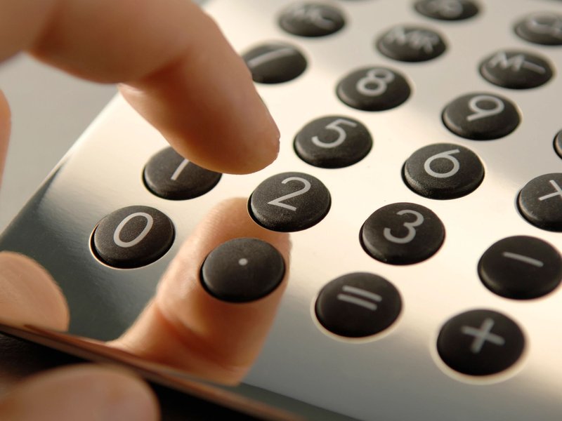 person dialing on a calculator from Life Style Floors in Andover, OH