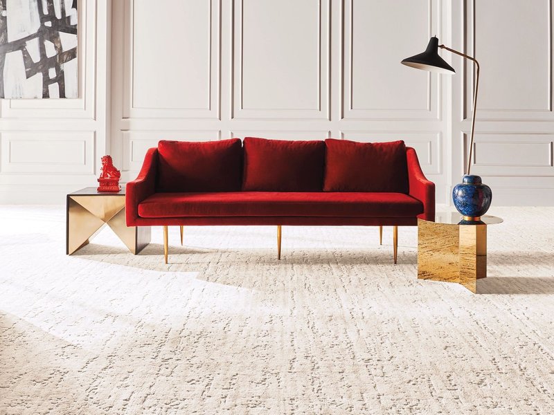 bright carpeted living room with a red couch from Life Style Floors in Chagrin Falls