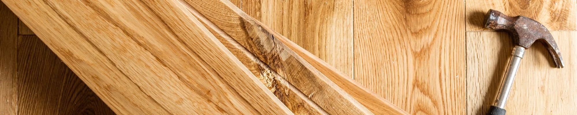 Hammer on a pile of wooden planks from Life Style Floors in Chagrin Falls, OH